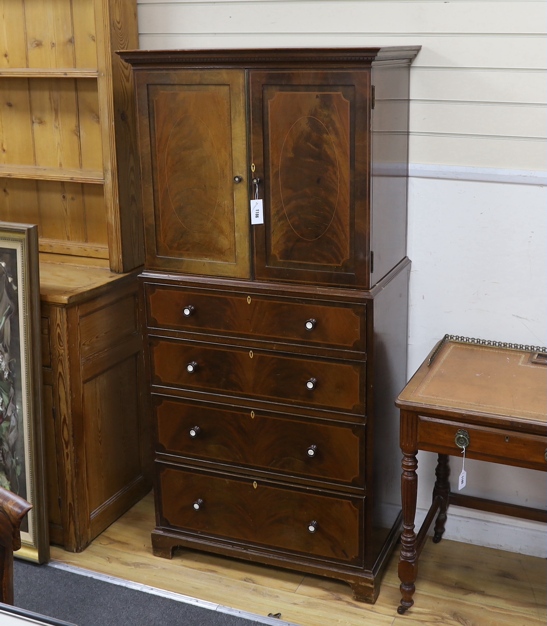 An early 20th century Maple & Co. mahogany narrow press cupboard, width 80cm, depth 45cm, height 168cm